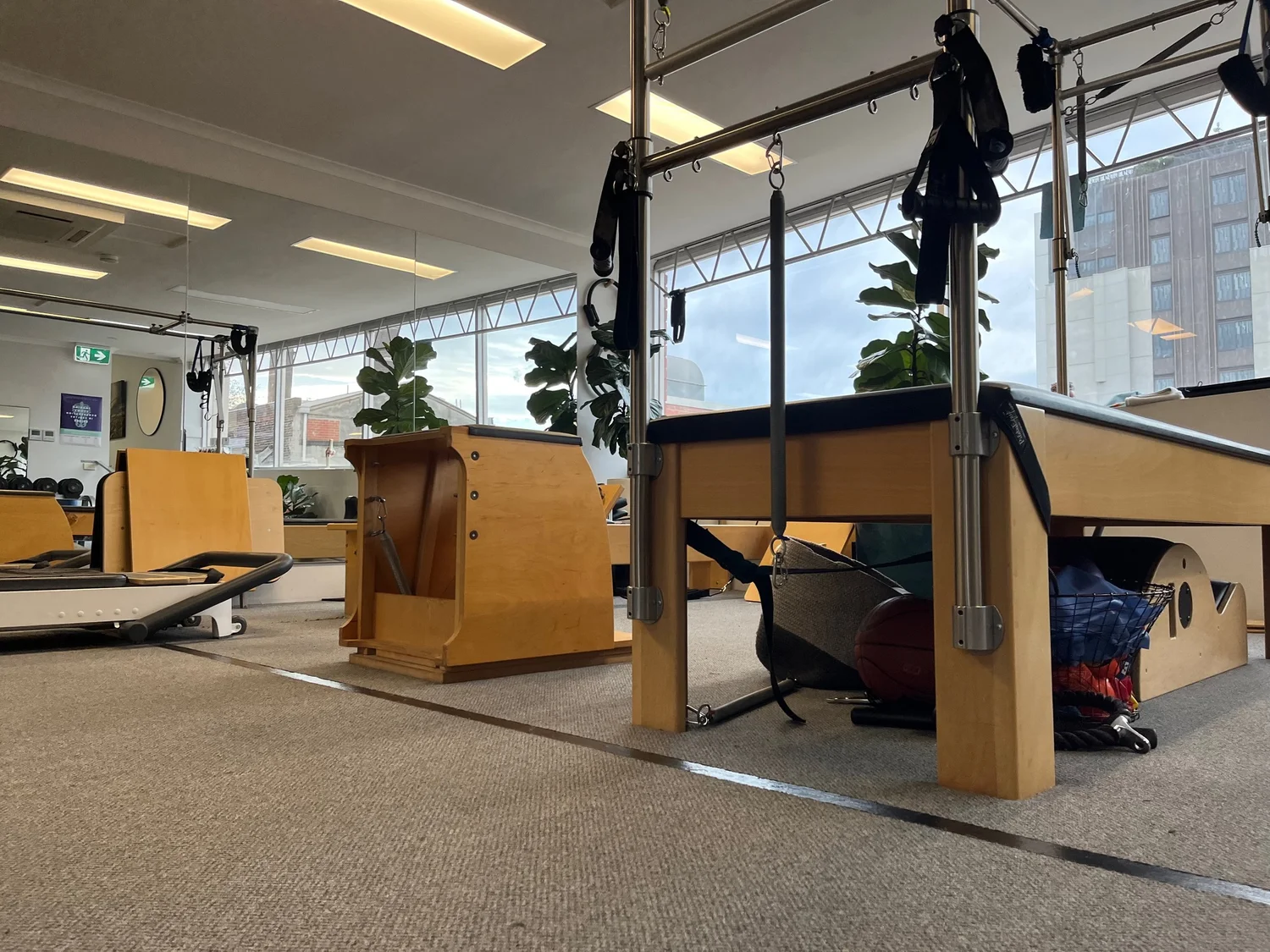 Richmond Rehab's Pilates studio — reformers, trapeze table and combo chairs by the studio windows